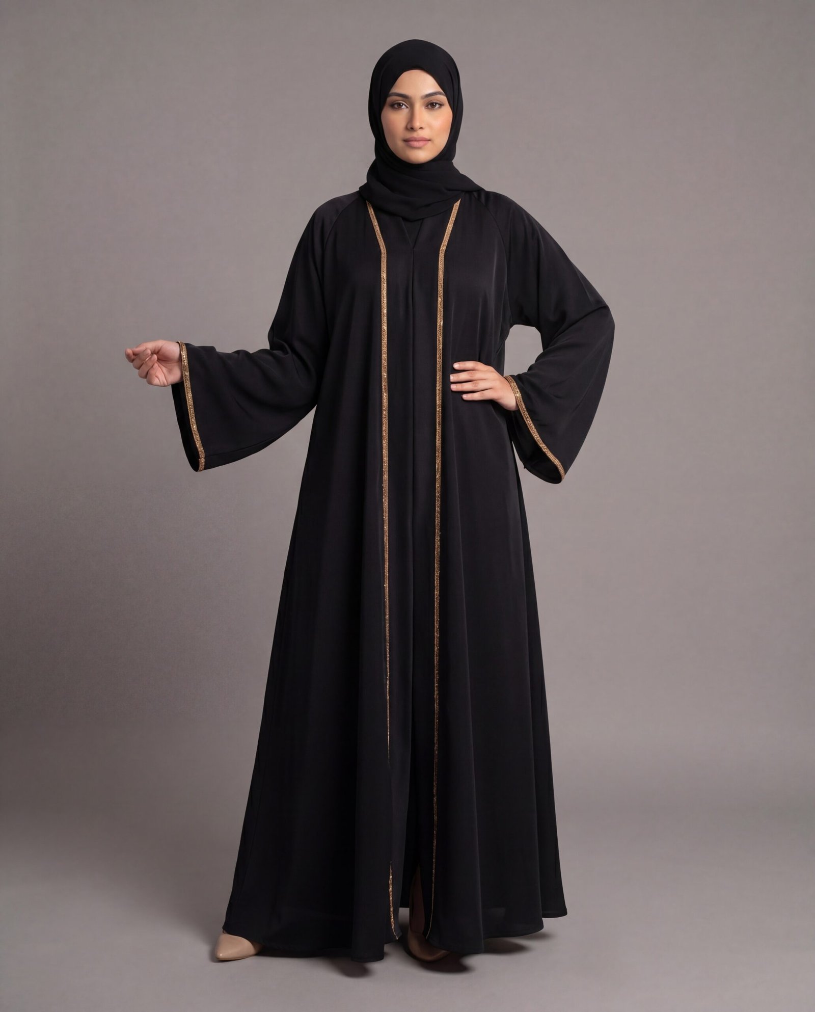 A solid black floor-length abaya featuring narrow gold borders along the collar, front opening, and wide cuffs.