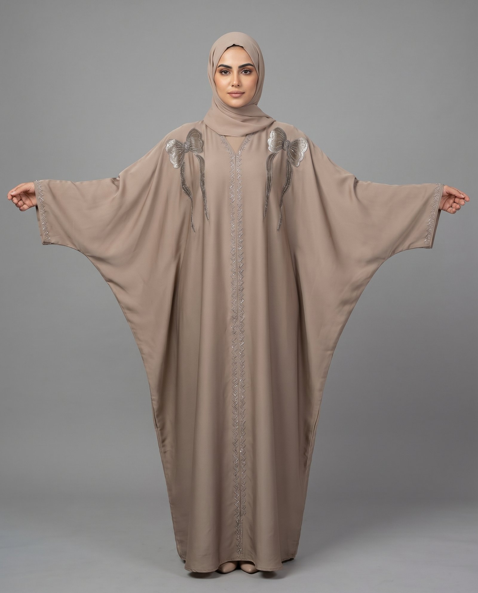 Elegant Malik Abaya Dubai Kaftan in light brown Imported Tiktok fabric with unique black bow and wheat-stalk embroidery details.